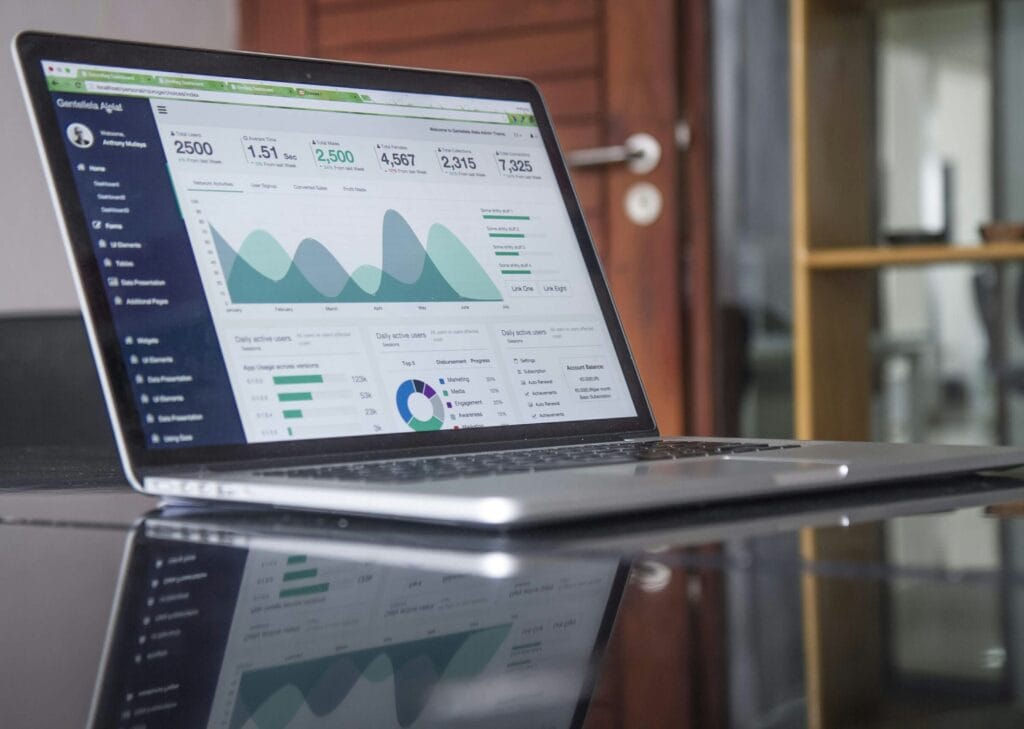 A laptop screen displaying a marketing automation dashboard with analytics and CRM metrics